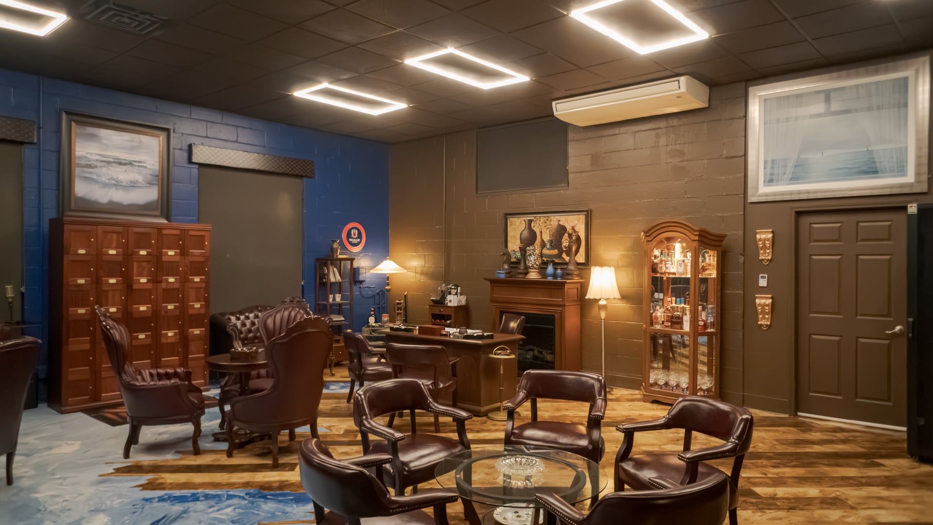 Leather seating, blue walls, and wooden lockers in The Bay Cigar Lounge’s Royal Room