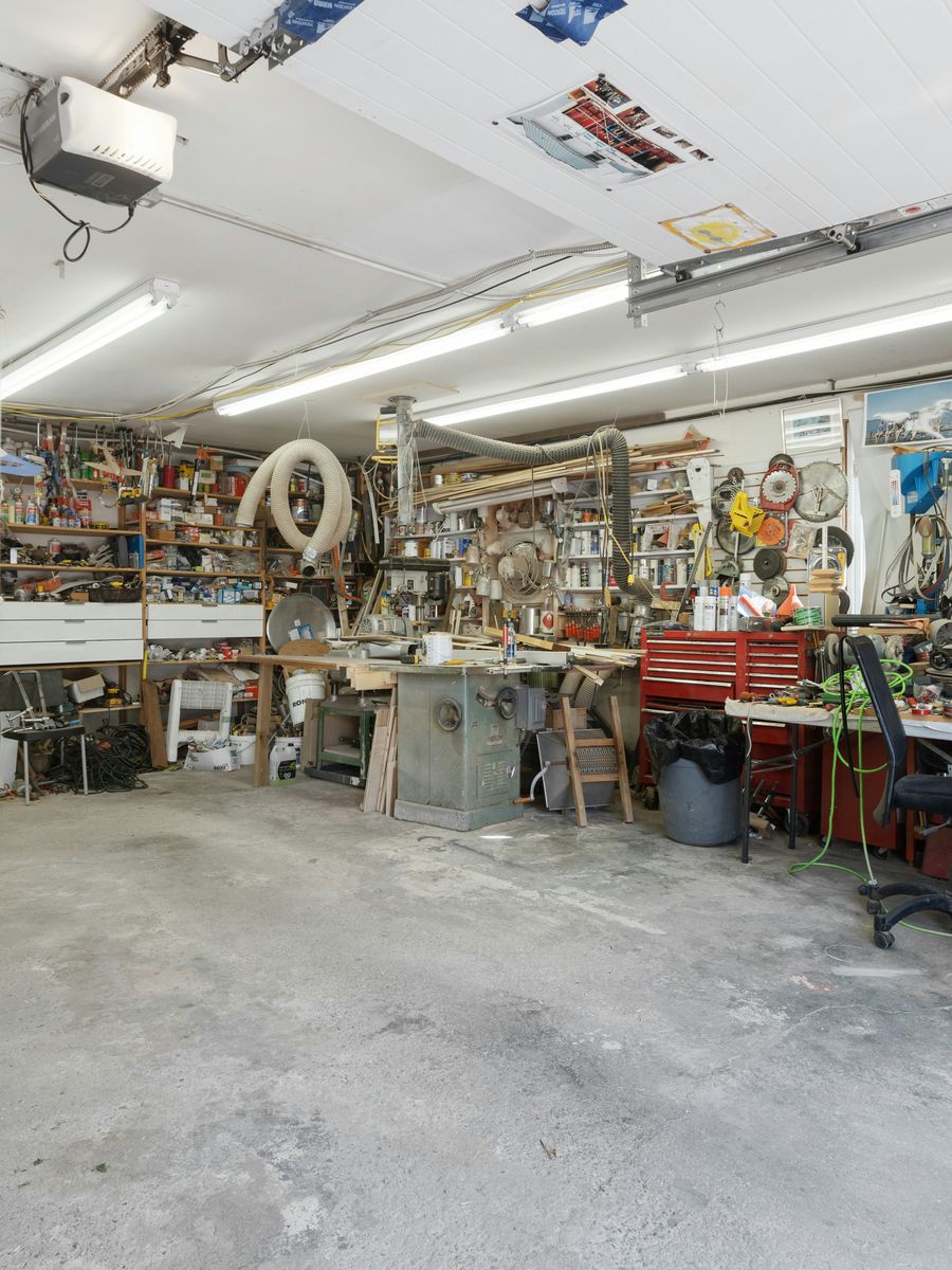 Stock photo of a garage packed with tools, shelving, and clutter