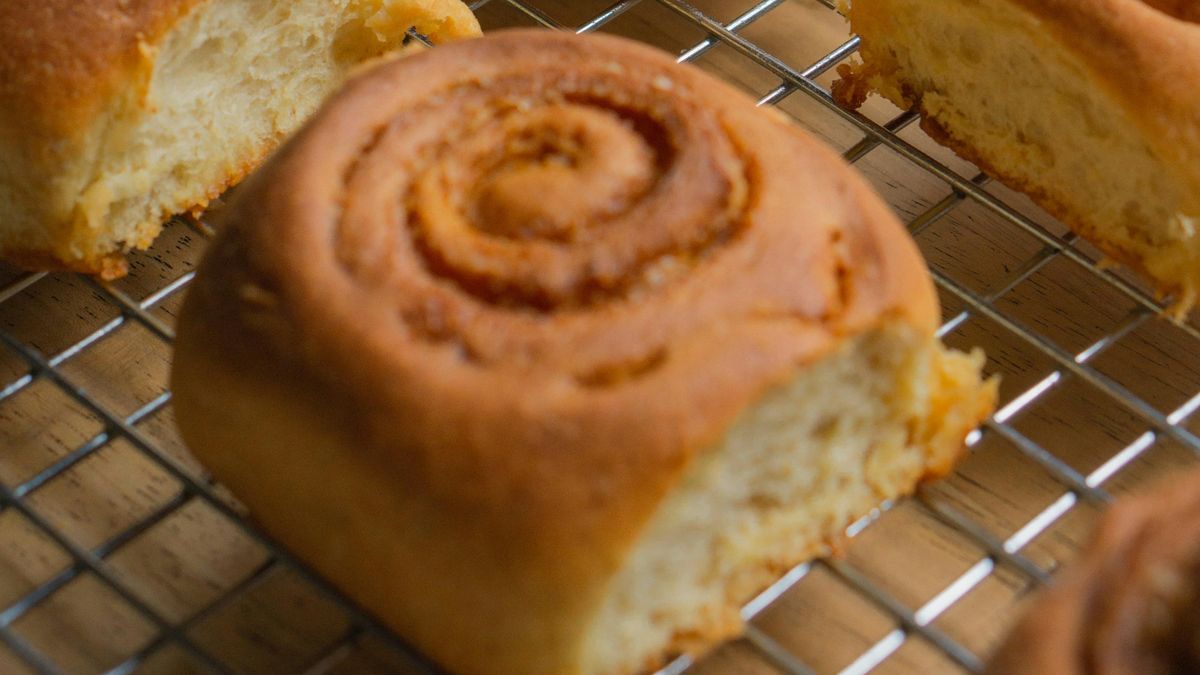 Cinnamon rolls cooling on a wire rack
