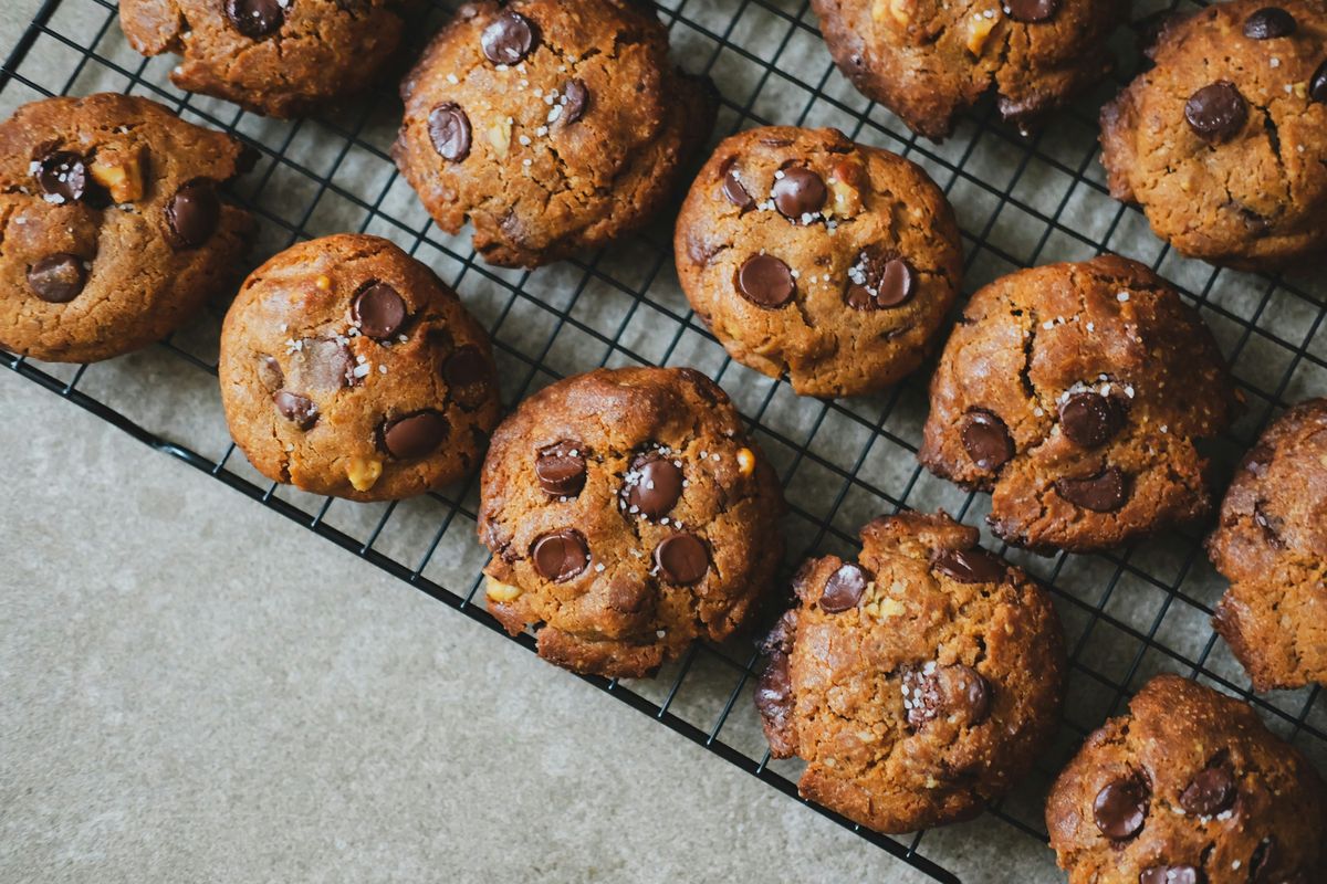 Chocolate chip cookies with flaky salt on a cooling rack